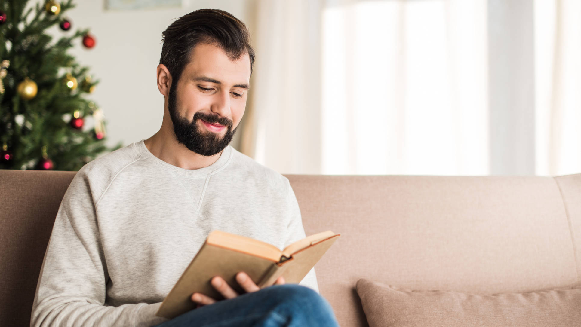 handsome man reading a book at home